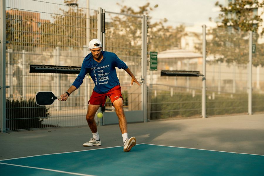 A player moving into a shot on a pickleball court